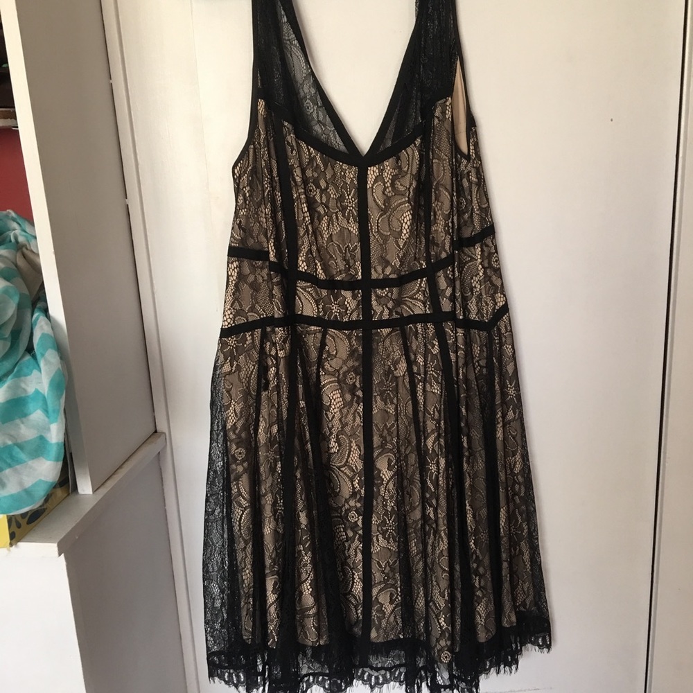 Black lace dress, with cream lining.